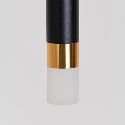 Closeup of black and gold cylindrical pendant light with frosted diffuser base showing premium detailing and fine finish.