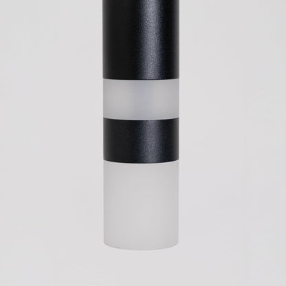 Closeup of elegant black cylindrical pendant light showing smooth matte finish and premium craftsmanship detailing.