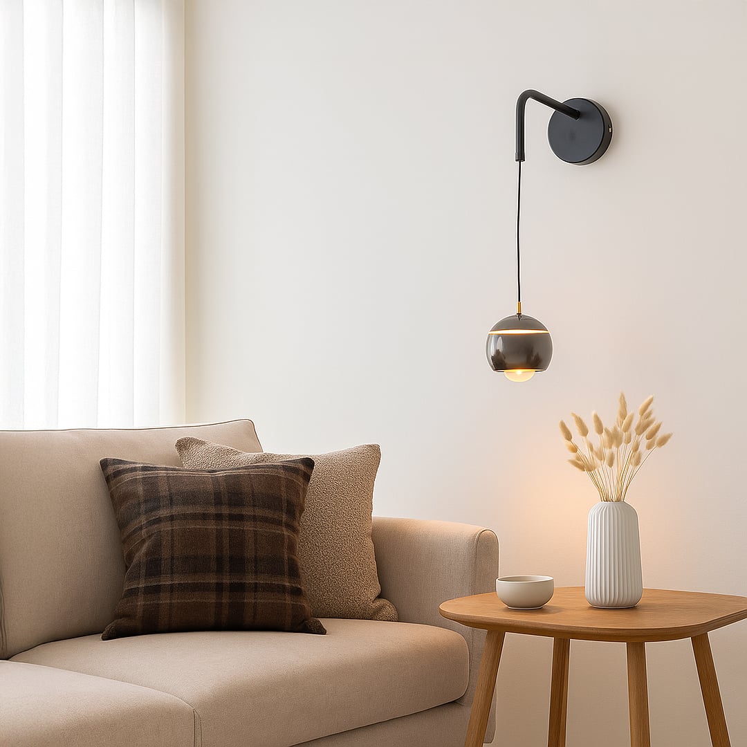 Table lamp style wall light shown in a bright lifestyle view with a modern hanging globe shade adding soft ambient lighting to interior spaces.