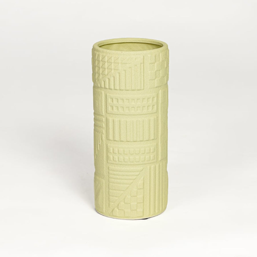 Yellow ceramic textured cylindrical vase with carved geometric detailing isolated on white background for contemporary home decor use.