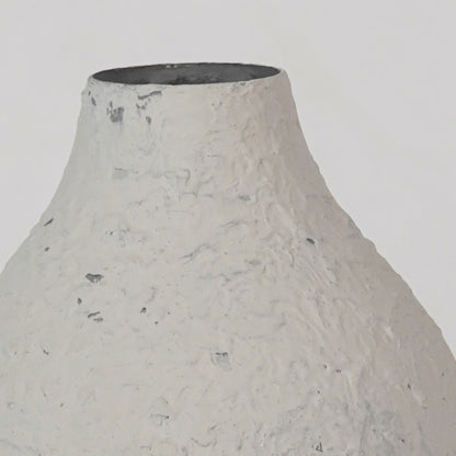 Detailed view of textured speckled white ceramic surface on artisan vase for refined modern home decor and style.