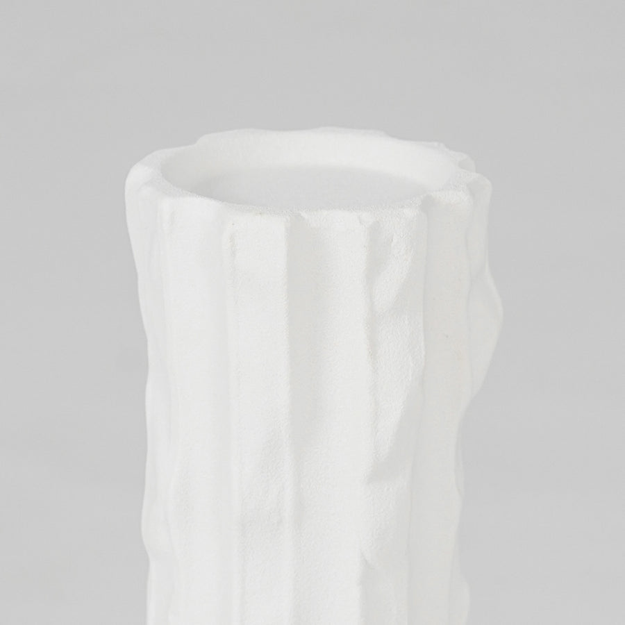 Closeup image of white ceramic textured vase for elegant shelf placement with smooth matte artistic finish styling.