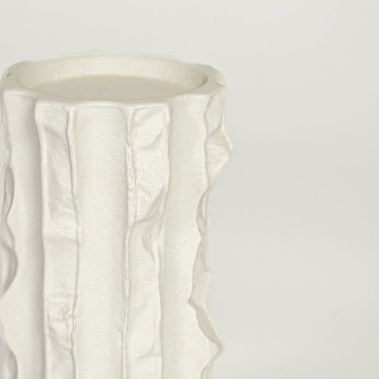 Closeup image of white ceramic textured vase for modern shelf placement with artistic matte finish styling display.