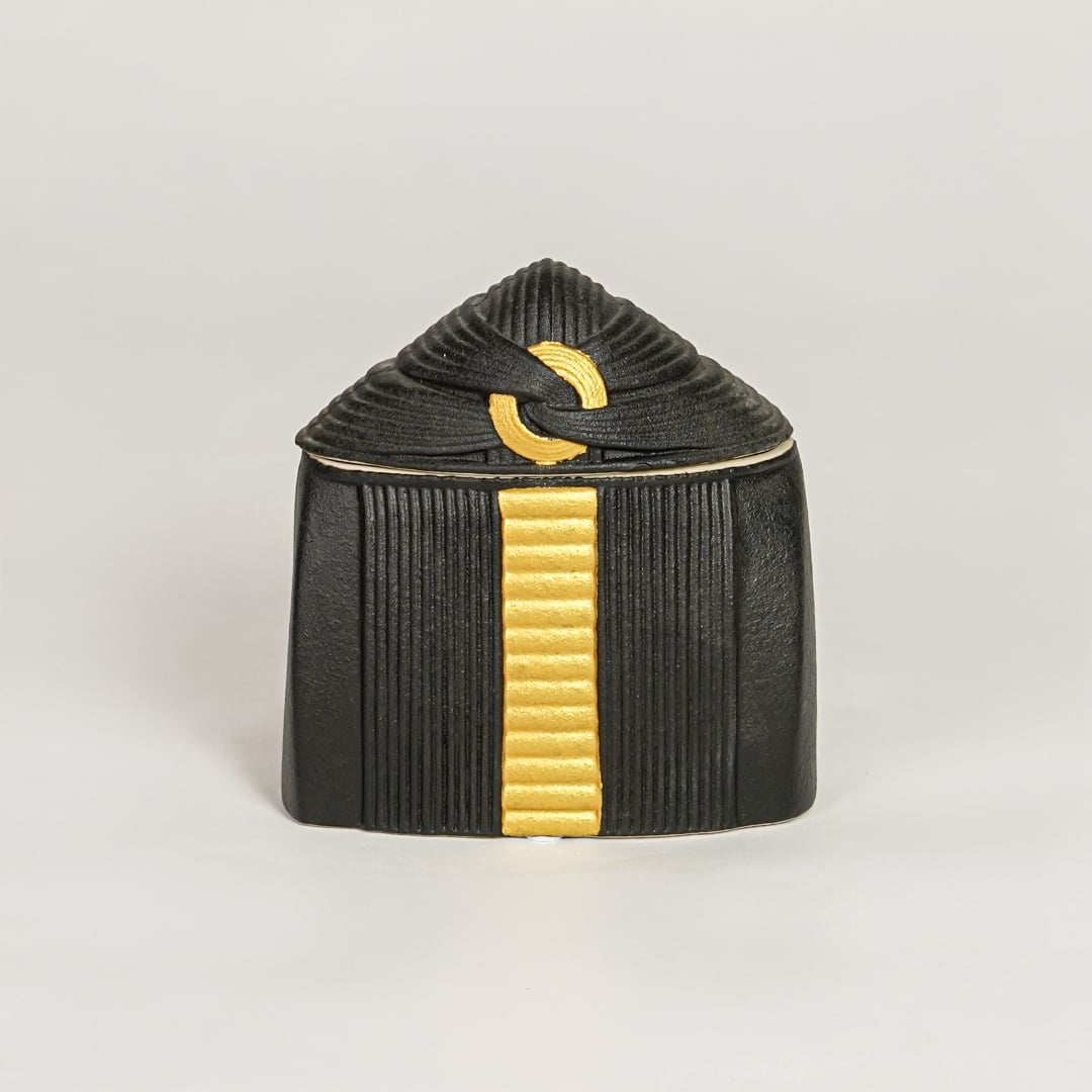 Black ceramic decorative jar with gold accent lid perfect for jewelry trinket storage on dresser vanity and modern decor.