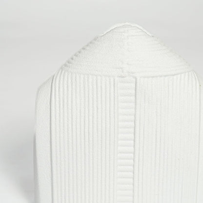 Detailed closeup of white ceramic dome vase showcasing vertical ribbed texture and smooth matte surface.