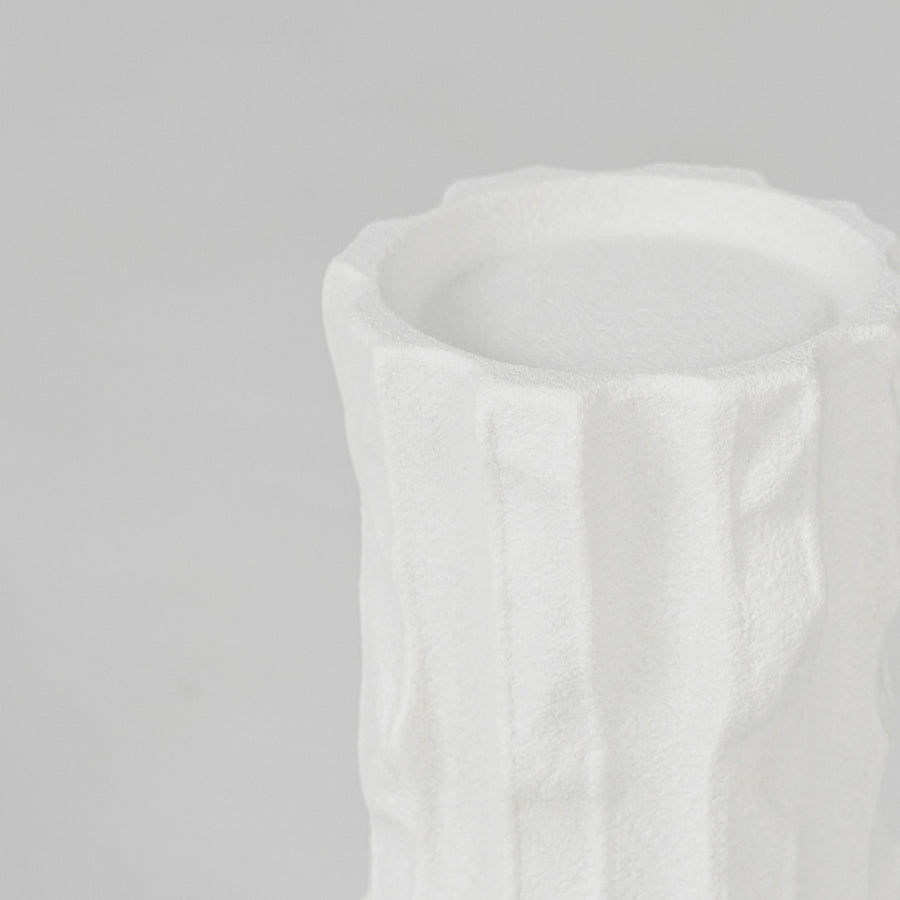Closeup image of white ceramic textured vase for modern tabletop decor styling with elegant matte finish display.
