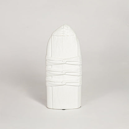 White ceramic sculpted decorative vase with vertical ribbed detailing isolated on white background for elegant home decor use.