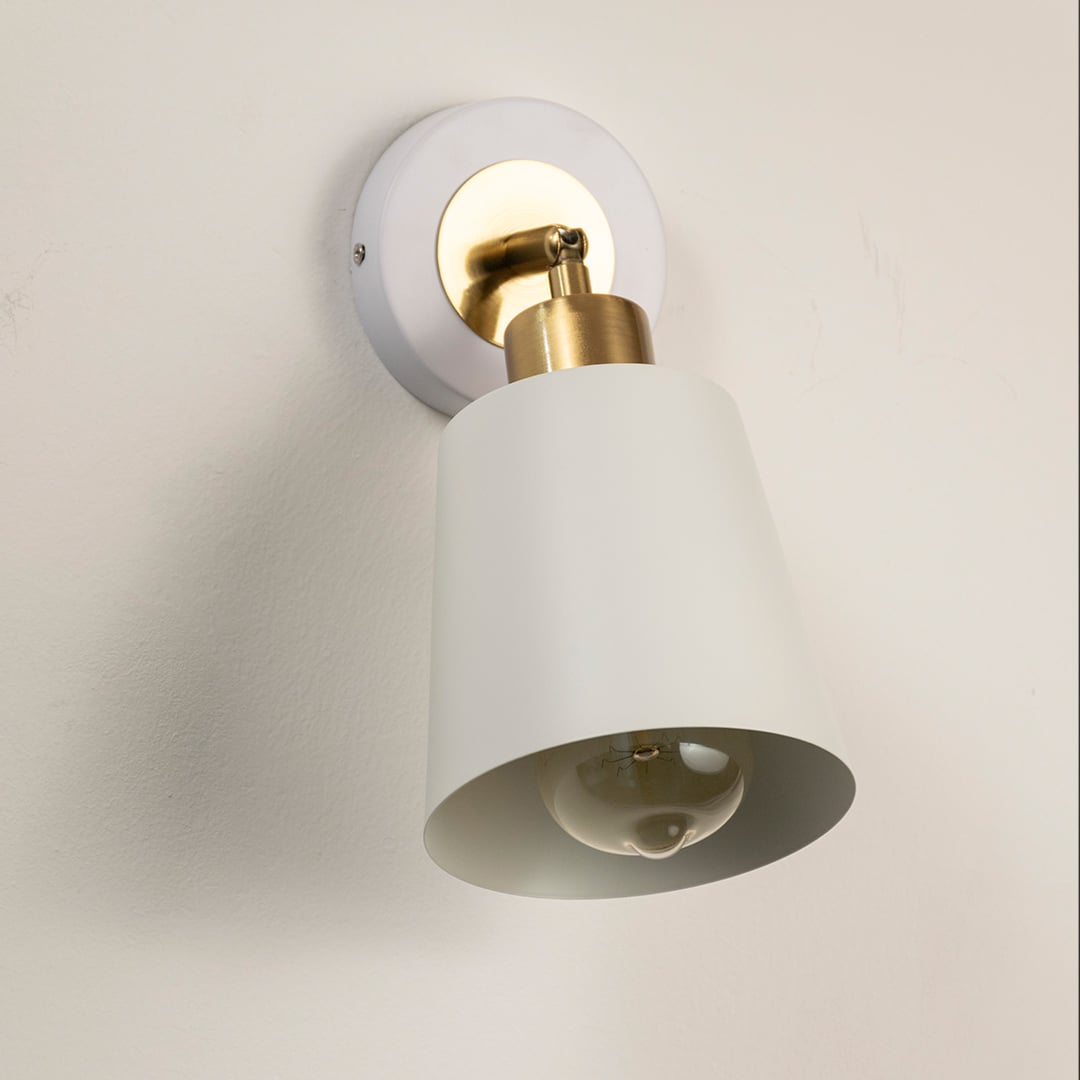 Modern white metal spotlight wall light with brass accents for elegant interior lighting decor.