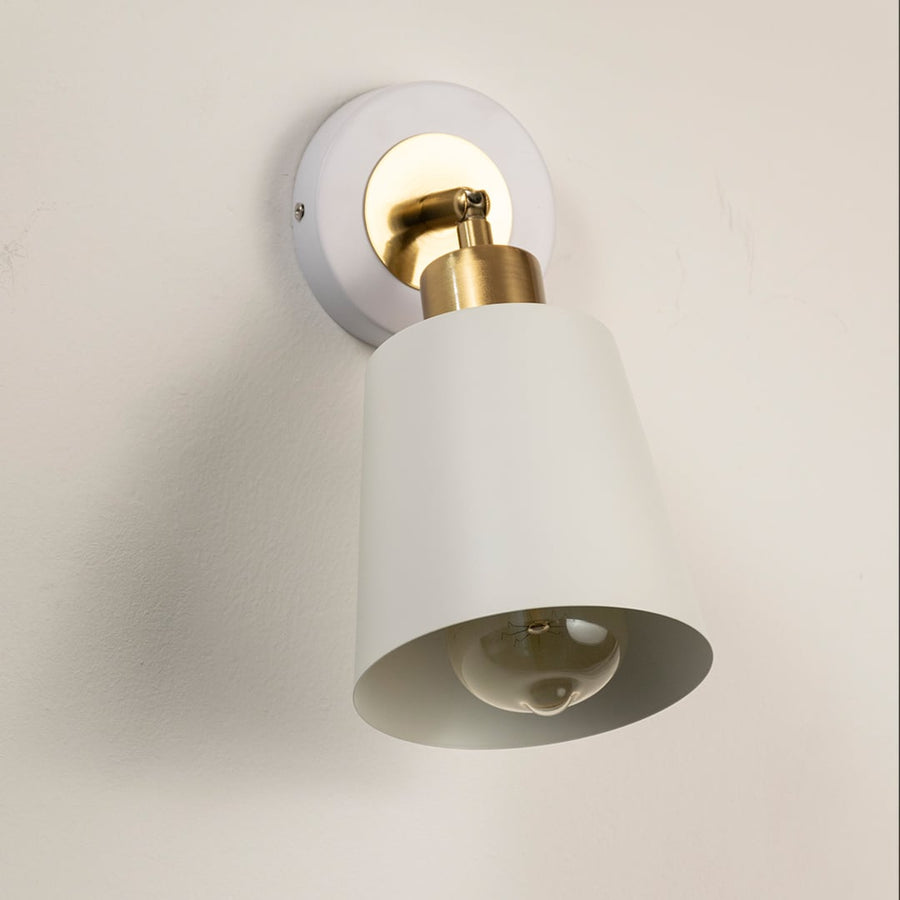 Modern white metal spotlight wall light with brass accents for elegant interior lighting decor.