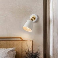 Contemporary white spotlight wall light creating cozy bedroom ambiance with warm interior lighting.