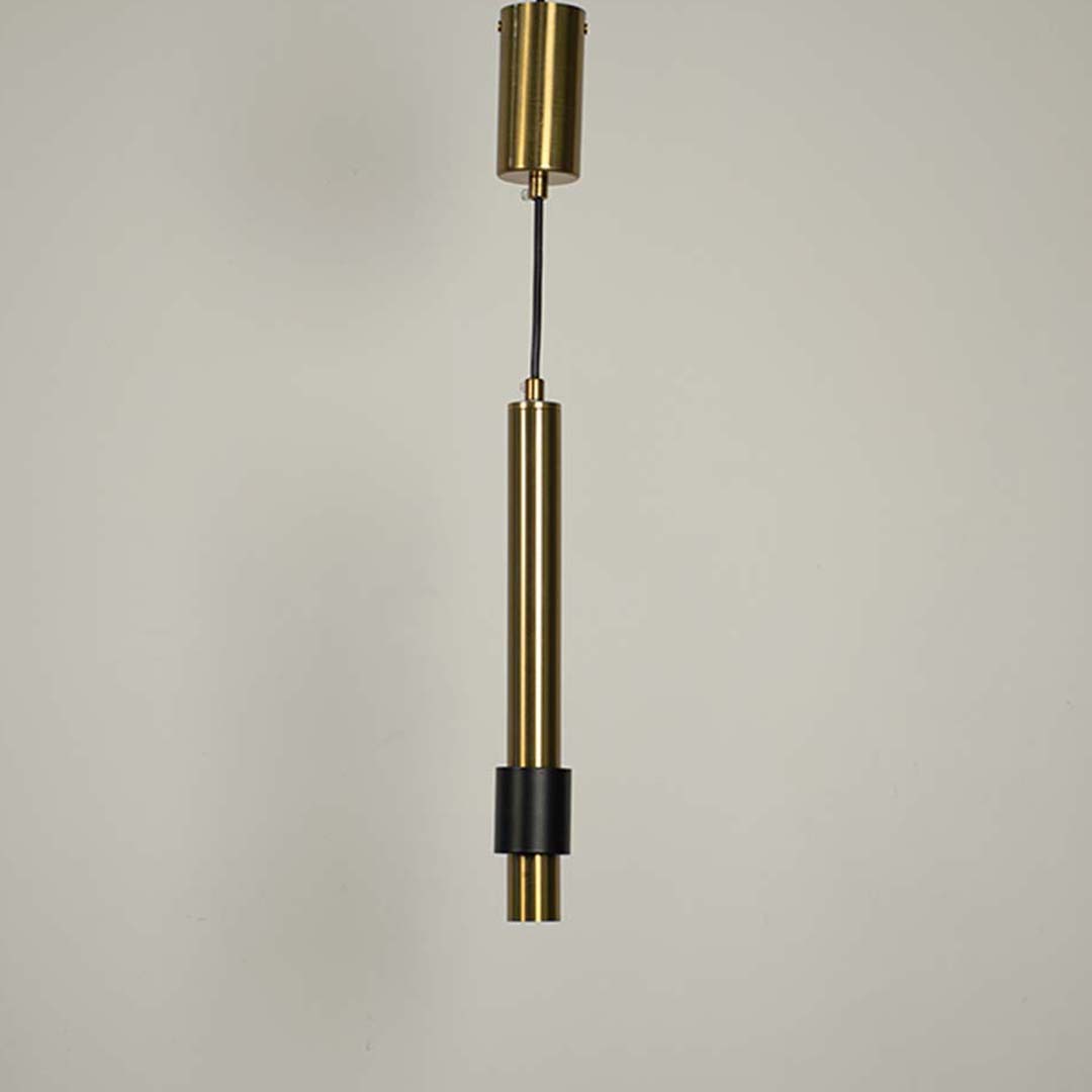 Black and brass metal cylindrical pendant light designed for elegant contemporary interior spaces.