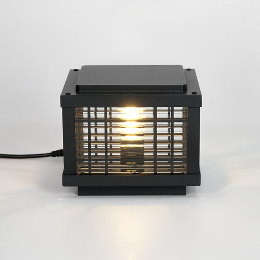 Black metal outdoor gate light with glowing bulb for stylish exterior decor styling use.