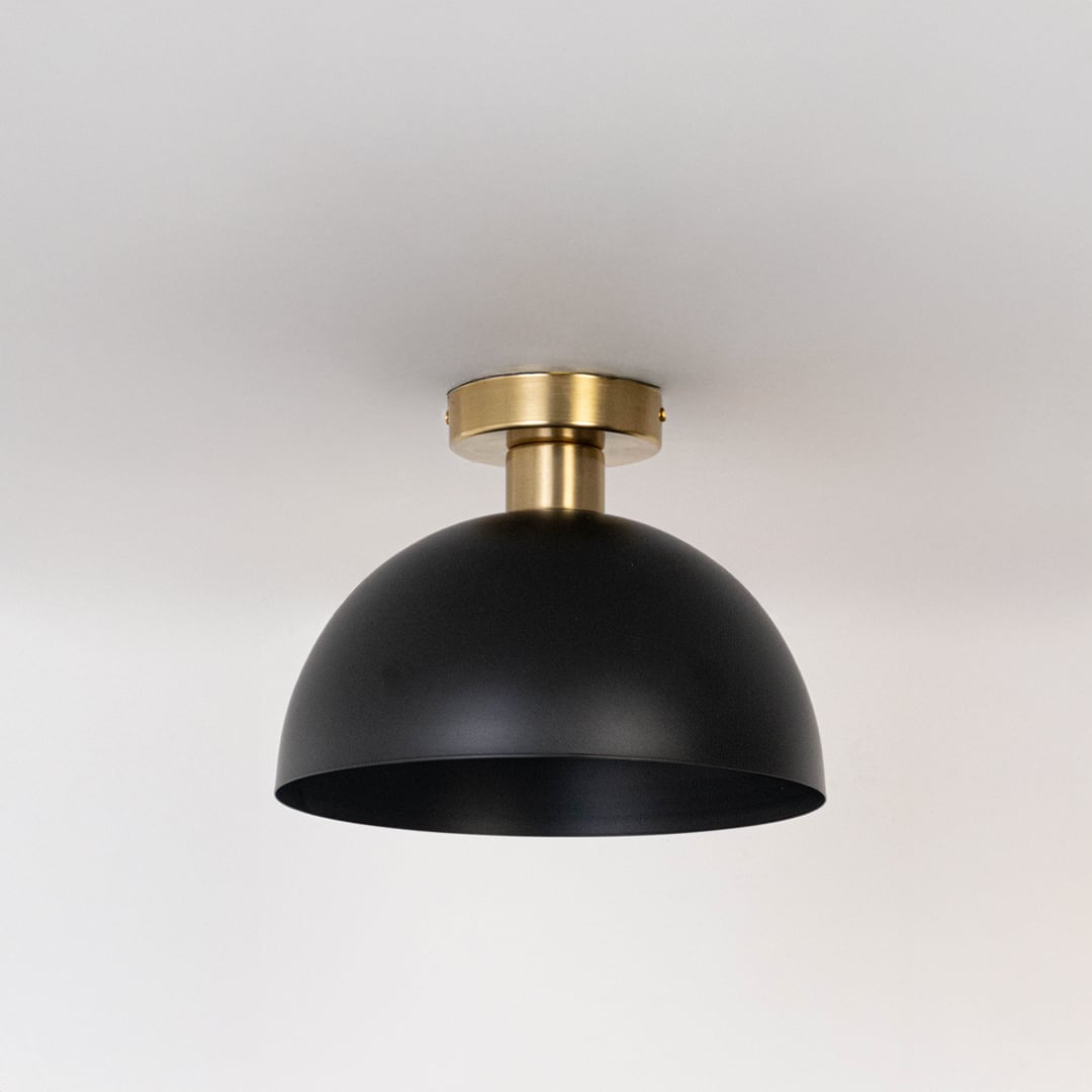 Black ceiling light with gold base and dome shade in off mode displayed on clean white background for modern ceiling decor.