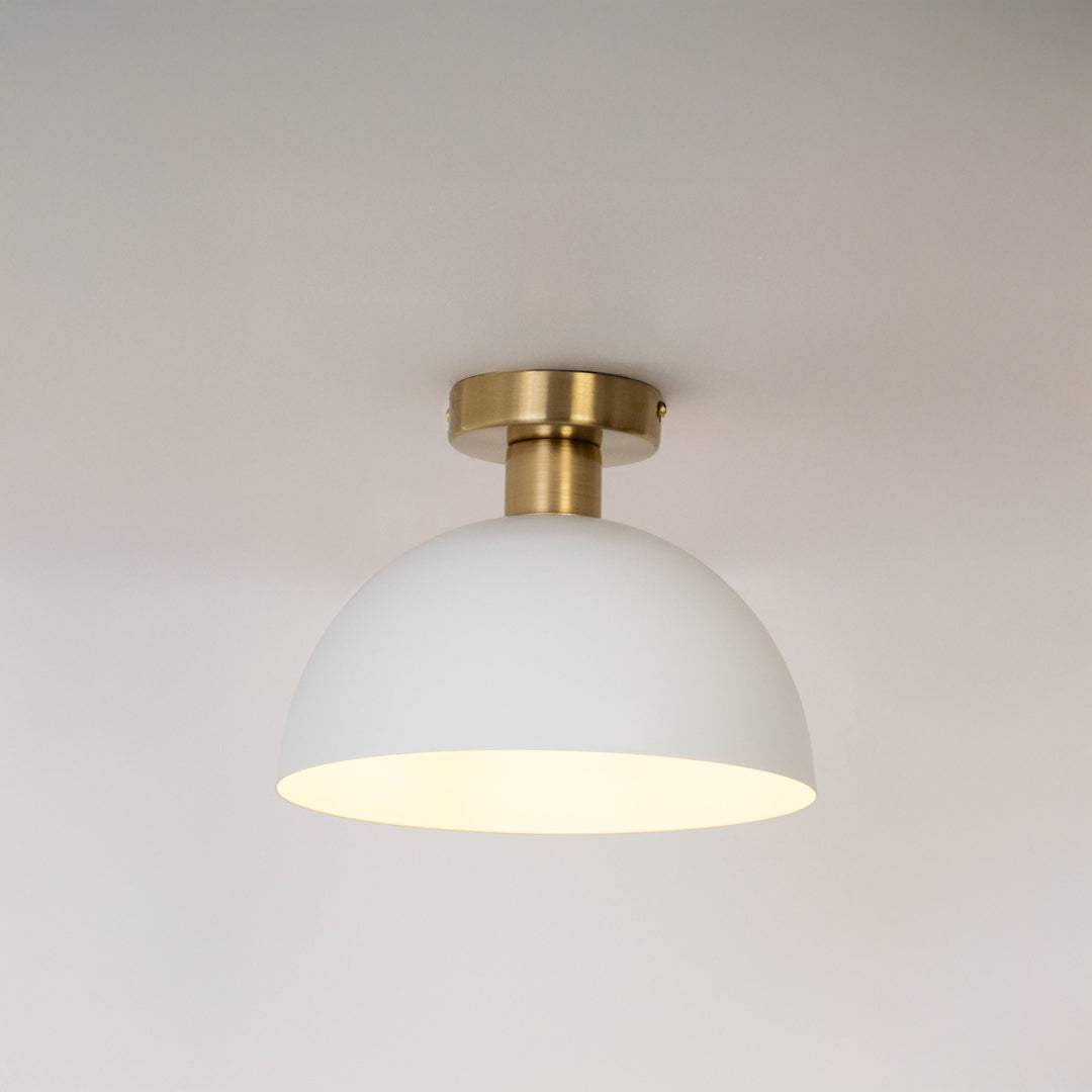 Modern white metal dome ceiling light with soft ambient lighting for elegant hallway and contemporary decor spaces.