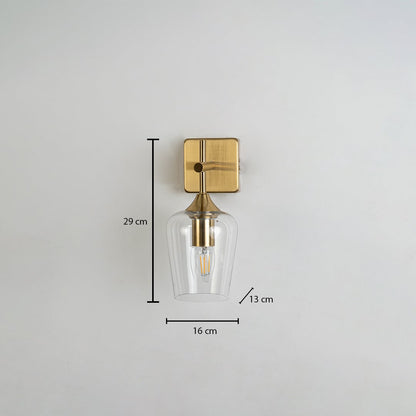 Clear glass wall light with gold metal base shown with measurements including 29 cm height 16 cm width and 13 cm depth clearly marked on a white background.