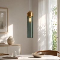 Lifestyle image of teal glass pendant light with gold accents enhancing elegant dining room spaces.