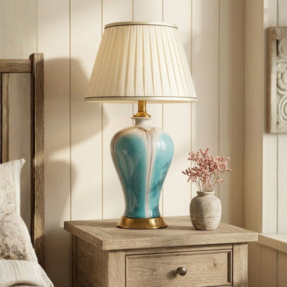 Lifestyle image of modern glazed blue ceramic table lamp for elegant bedroom decor styling and modern home room lighting.