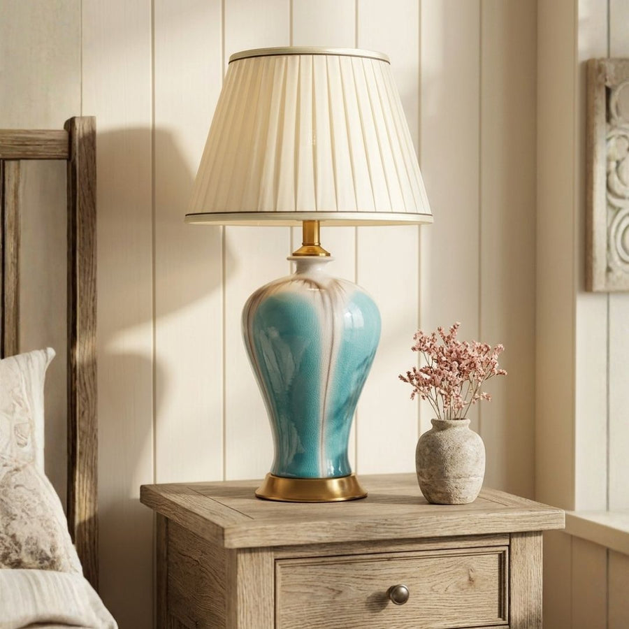 Lifestyle image of modern glazed blue ceramic table lamp for elegant bedroom decor styling and modern home room lighting.