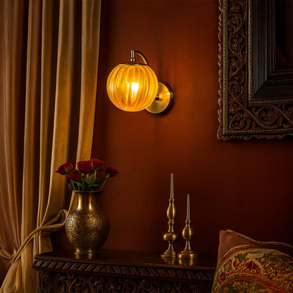 Vintage style wall light glowing warmly on textured brown wall beside classic decor creating rich ambient lighting for elegant living room interior atmosphere.