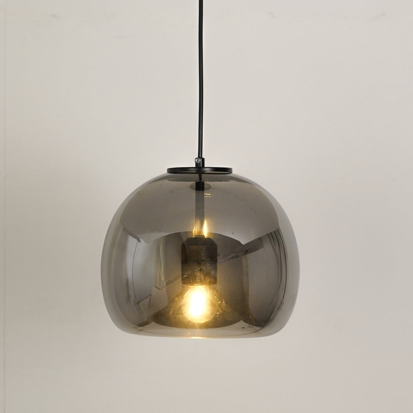 White background image of modern black metal pendant light for elegant dining room decor styling with bright illumination.