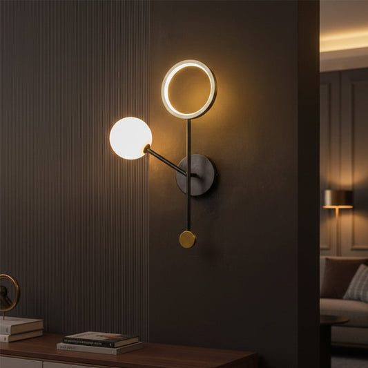 Modern black and gold LED wall light with warm glow for luxury bedroom and contemporary home decor spaces.