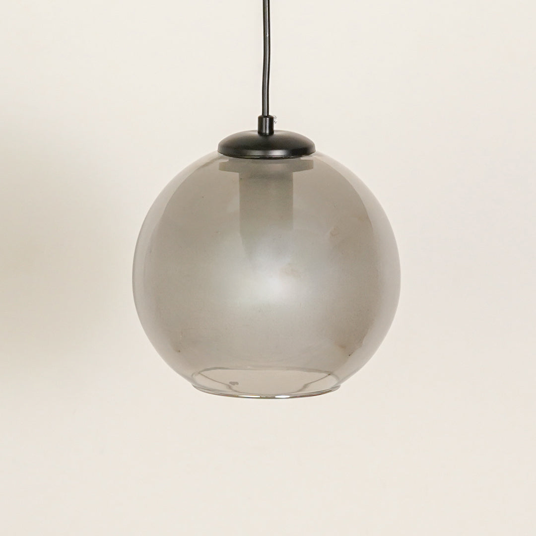 Frosted smoked glass pendant light with black fittings for refined contemporary spaces.