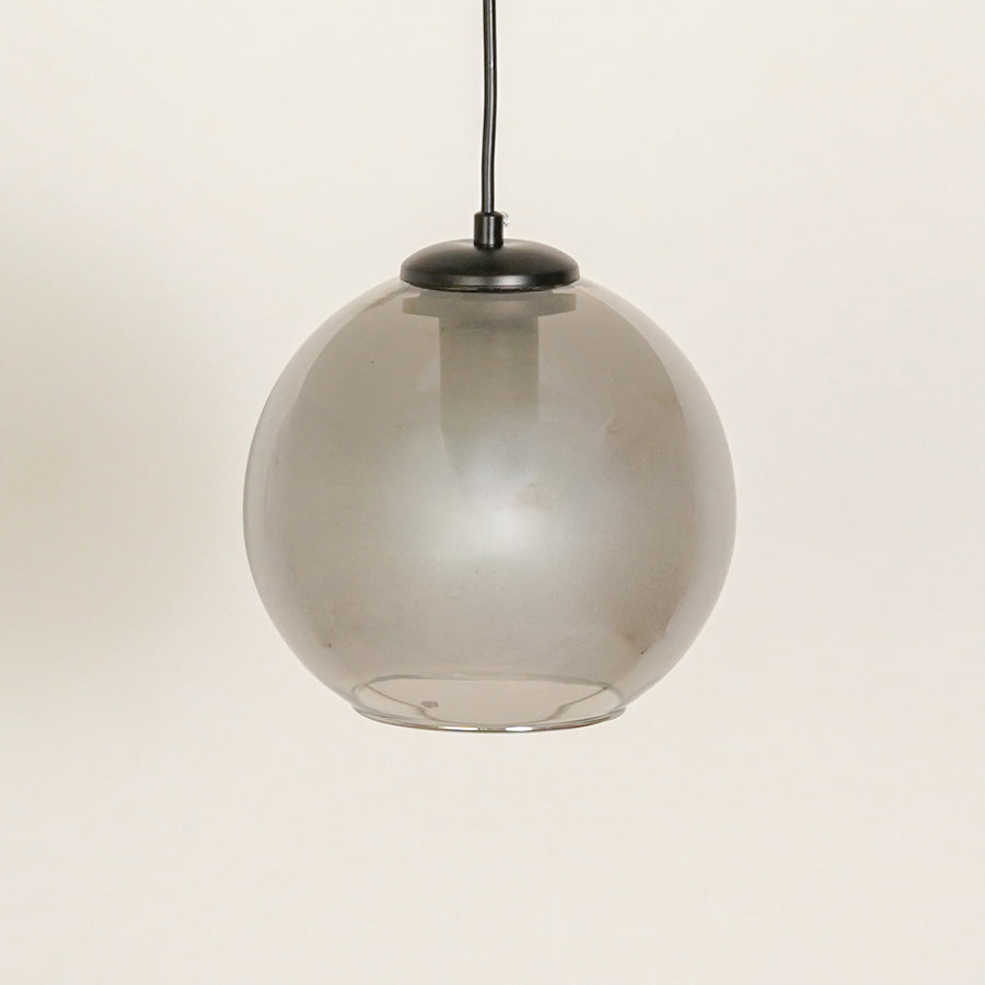 Frosted smoked glass pendant light with black fittings for refined contemporary spaces.