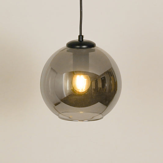 Smoked glass pendant light illuminated beautifully for elegant ceiling lighting decor.