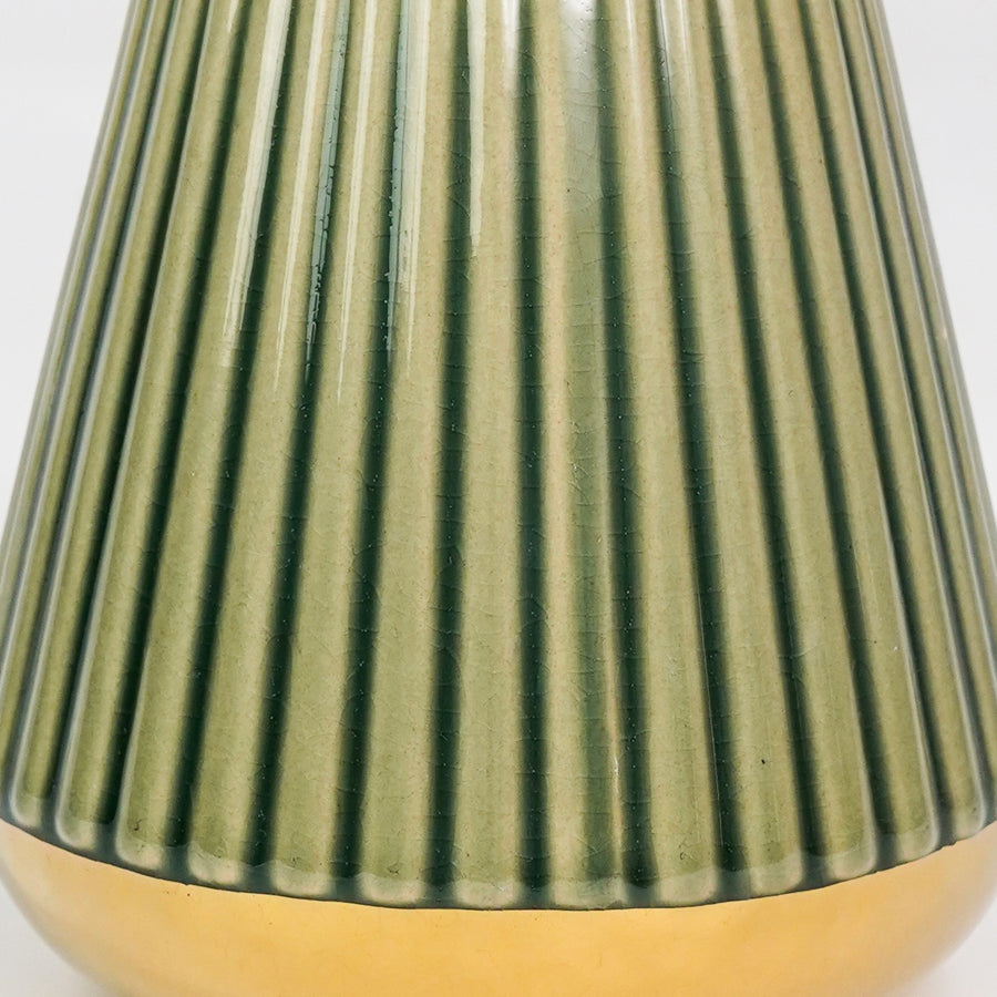 Closeup image of minimalist green gold ceramic vase for elegant tabletop decor styling highlighting modern smooth finish.