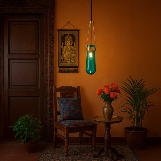 Elegant blue glass pendant light with gold frame hanging in a modern room with soft ambient lighting and bright illumination creating a calm decor feel.