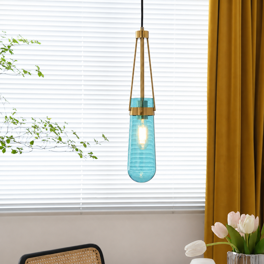 Lifestyle image of modern minimalist hanging glass water drop pendant light for elegant dining room decor styling and modern home lighting design.