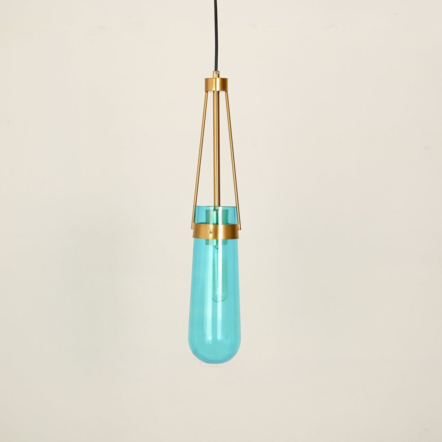 White background image of modern minimalist hanging glass water drop pendant light for elegant dining room decor styling and modern home lighting.
