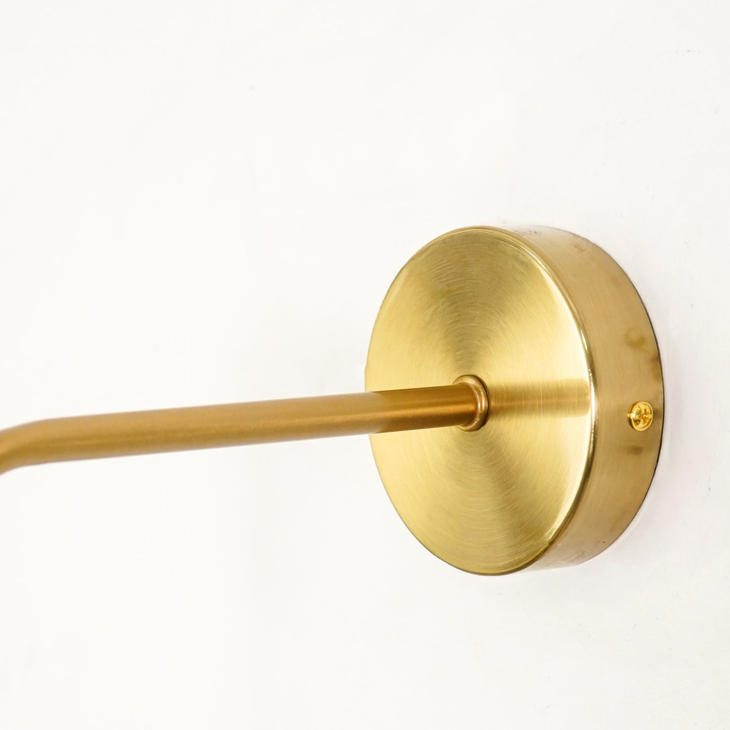 Closeup image of modern nordic golden wall lamp for elegant bedroom decor styling highlighting smooth metal gold finish.