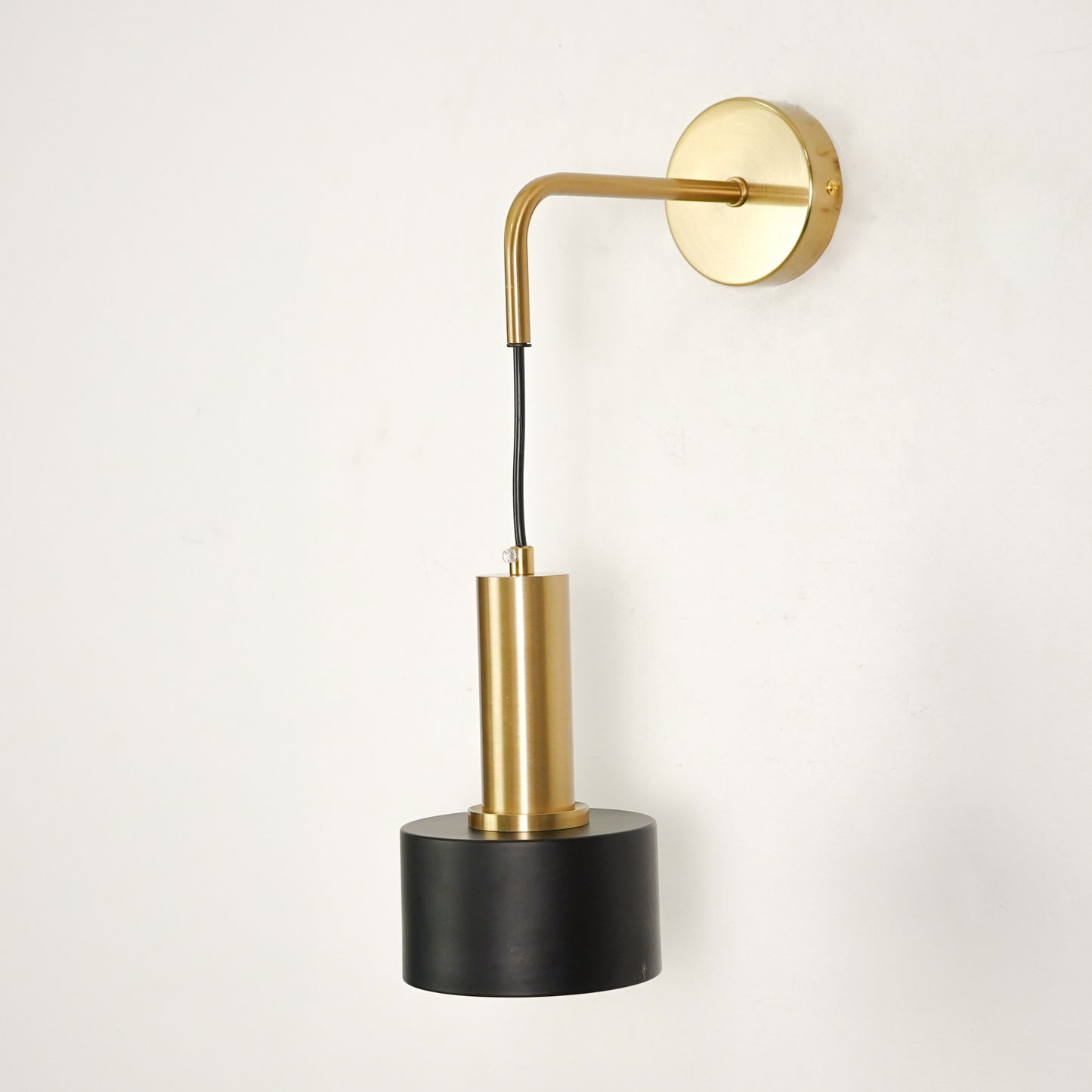 White background image of modern nordic golden wall lamp for elegant bedroom decor styling with sleek unlit gold finish.