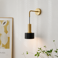 Lifestyle image of modern nordic style golden wall lamp for elegant bedroom decor styling with luxurious metallic finish.