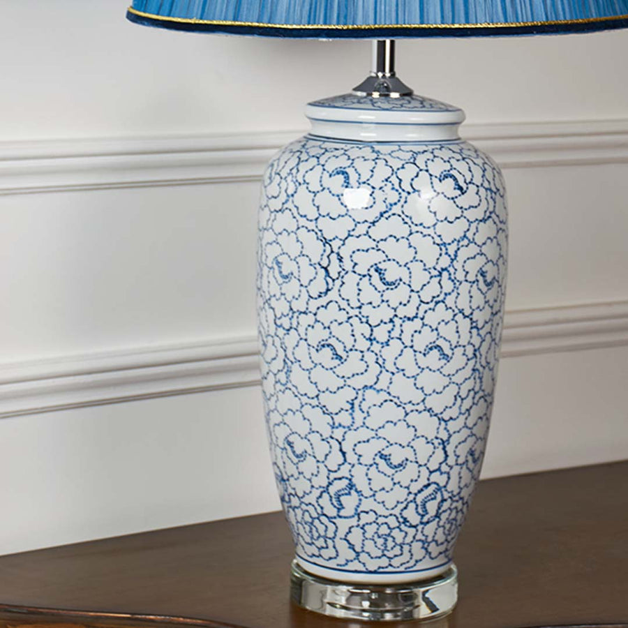 Blue and white crackle pattern ceramic table lamp showcasing handcrafted detailing with a glossy finish and silver base.