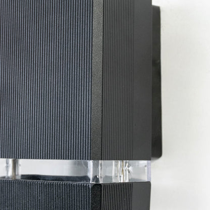 Detailed view of compact rectangular wall light featuring ribbed matte finish and frosted glass diffuser strip.