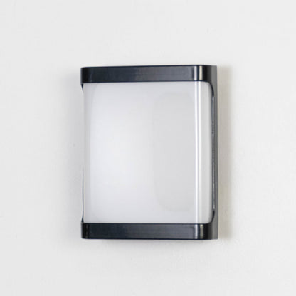 Contemporary black wall light with frosted shade displayed off on plain white background.