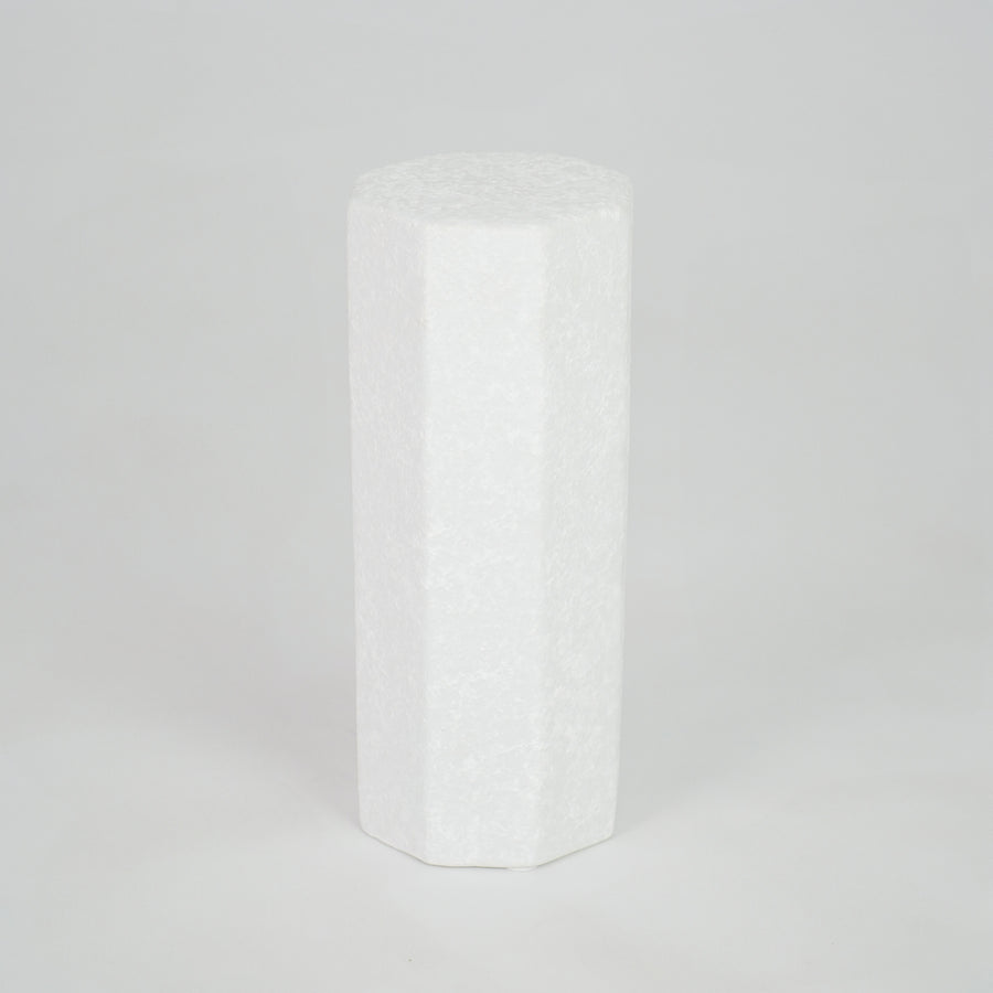 White geometric ceramic vase for modern shelf placement and contemporary indoor home decor styling accent piece.