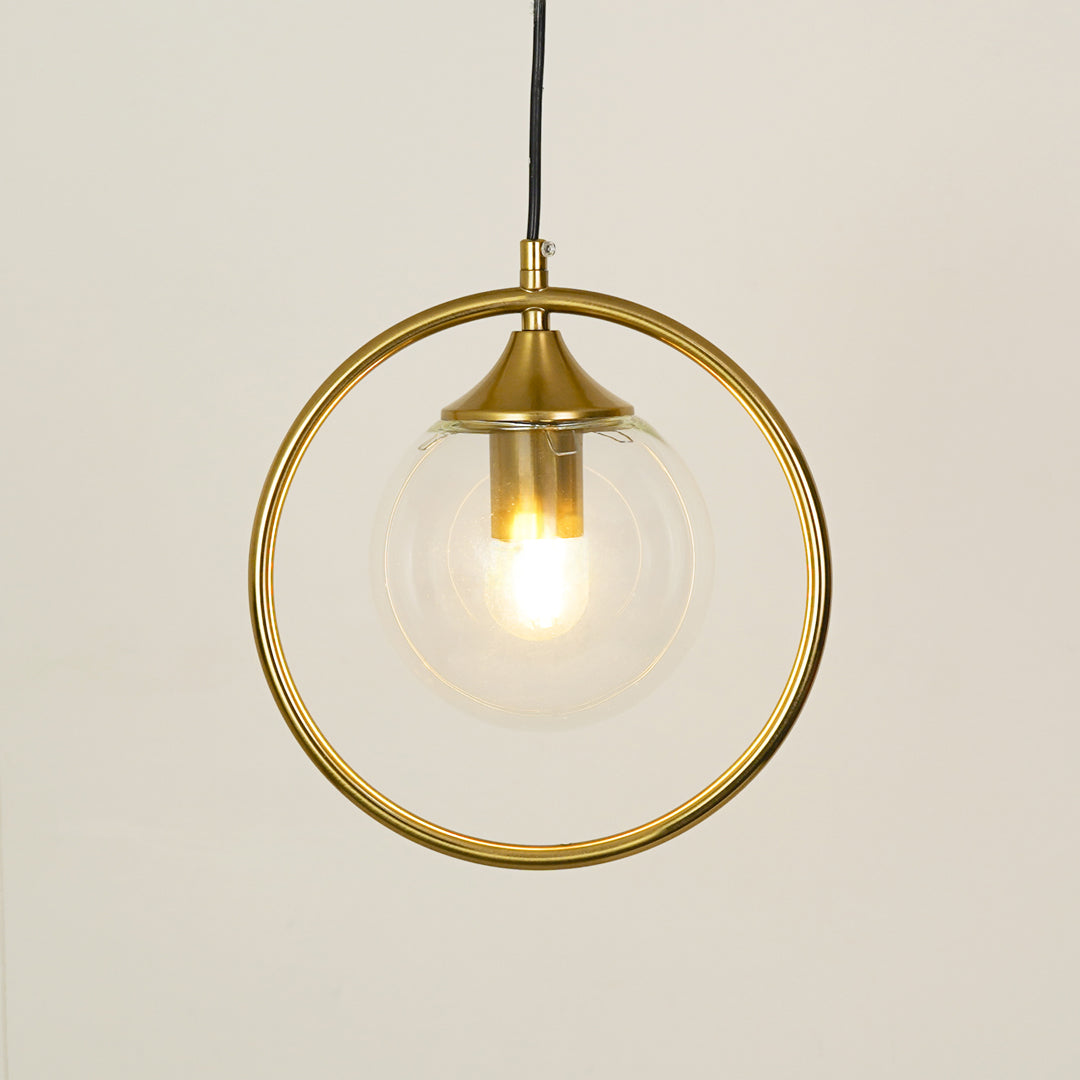 Gold ring pendant light with clear glass shade illuminated for refined luxury ceiling decor.