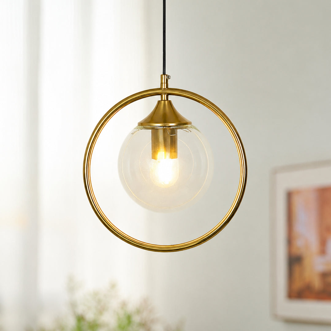 Gold ring pendant light with clear glass shade suspended beautifully in bright modern interior decor.