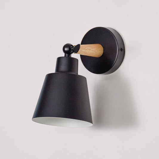 Contemporary wall lamp shown on white background emphasizing smooth metal shade natural wood accent and simple mounting plate for modern interiors.