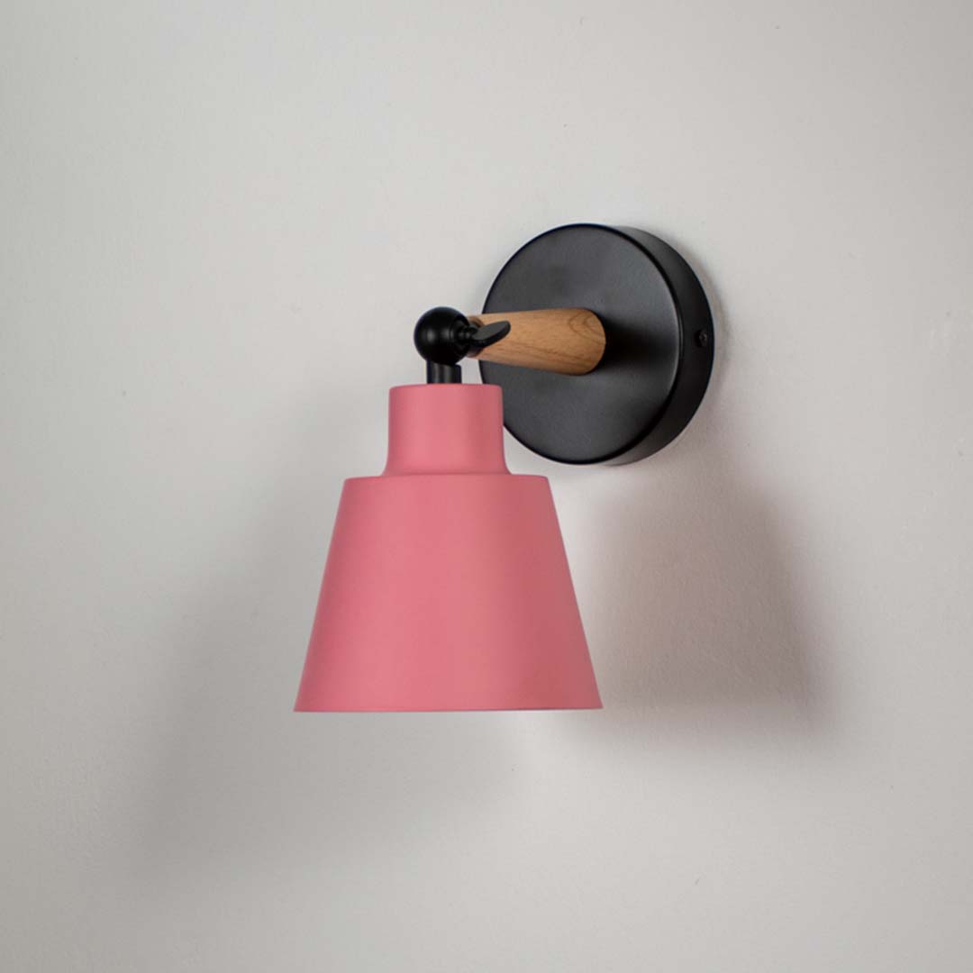 Wooden wall sconce with pink conical lampshade light off white background for bedroom study and hallway modern decorative wall lighting decor.