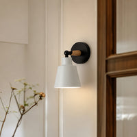 Modern black metal wall light with white fabric shade for bedroom bedside and contemporary home ambient lighting.