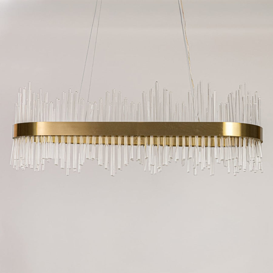 Gold metal chandelier with vertical glass rods displayed with lights off on a white background showing its sleek contemporary structure.