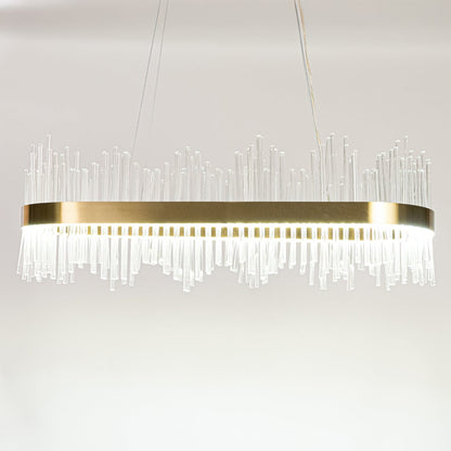 Gold metal chandelier with layered glass rods shown with lights on against a white background emphasizing its warm glowing upscale design.