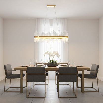 Gold metal chandelier with clear glass rods glowing warmly above a modern dining table creating an elegant bright and luxurious interior atmosphere.