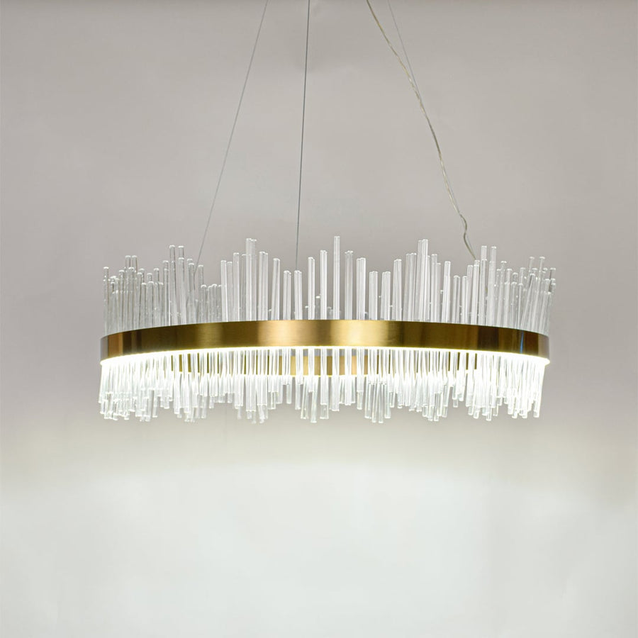 Contemporary gold metal chandelier with bright glass rods offering elegant ceiling lighting for living room interiors.