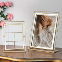 Gold metal photo frame styled on a console table for elegant tabletop decor and contemporary home interiors.