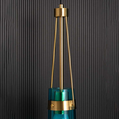 Closeup view of the blue glass pendant light focusing on the gold frame connection and smooth tinted glass surface for detailed visual clarity.